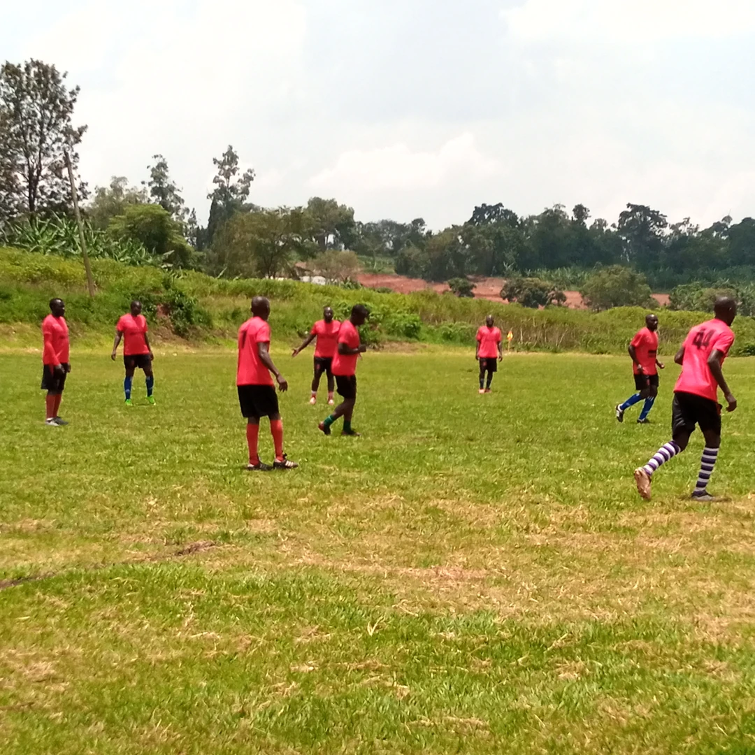 Men warming up on a grass field